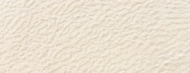 white sand in clear water on the beach, seashore top view