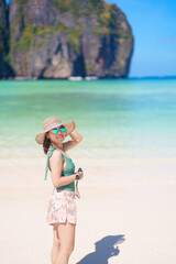 Fototapeta premium Woman tourist traveling and sightseeing in Krabi, Thailand, happy traveller enjoy at Maya Bay beach on Phi Phi island, Popular paradise island, destination, Southeast Asia Travel, vacation and holiday