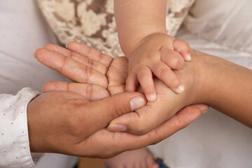 Little tiny delicate newborn human baby hands close up