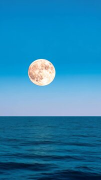Moon Over Tranquil Sea with Blue Skies in Vertical Video Format, 916 Aspect Ratio, Ideal for Serene Nature Backgrounds and Celestial Themes.