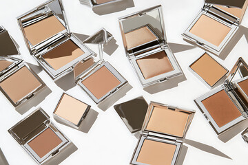 Showcase of stylish makeup powders beauty studio product photography minimalist setting top-down view cosmetics collection