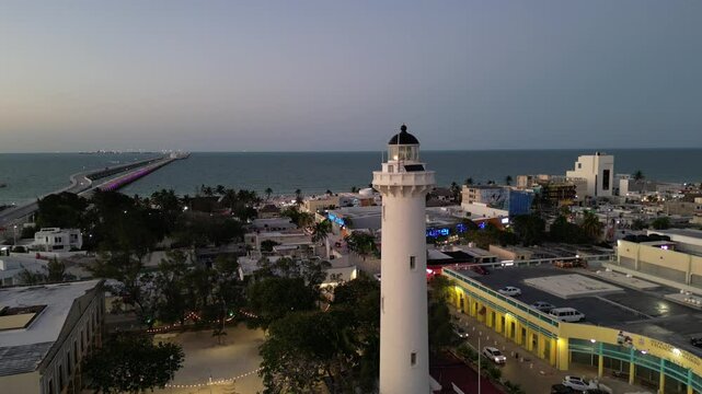 aerial view of lighthouse in progreso mexico yucatan state (coastal beach town with long pier at sunset) dusk dark nightfall night busy port travel tourism destination coast seafood famous landmark