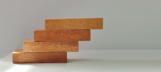Wooden block stacking exercise minimalist studio photography indoor eye-level conceptual growth