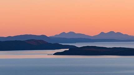 Fototapeta premium Serene Sunset Landscape: Silhouetted Mountains and Calm Waters