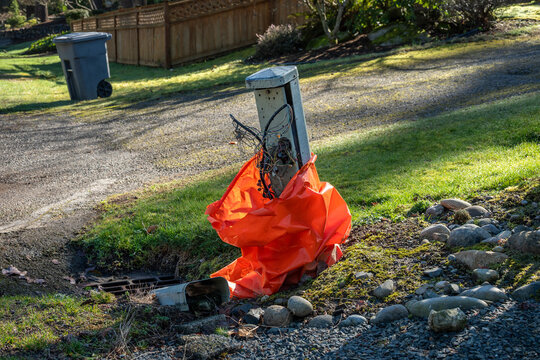 Old and broken public switched telephone network residential Cross Connect box pedestal on sunny winter day
