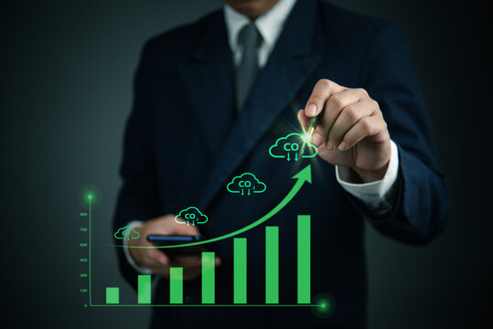 businessman analyzing carbon emissions data with futuristic green bar chart and CO2 reduction concept. sustainability, environmental responsibility, and corporate efforts to reduce carbon footprint.