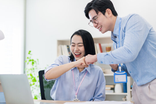 Colleagues celebrate success in a modern office setting during a collaborative meeting