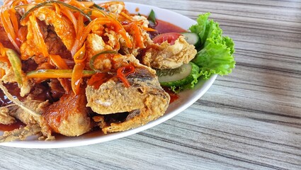 Gurame asam manis in plate on the table. Copy space.