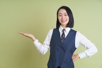 Professional young woman in formal attire showcasing confidence and friendliness indoors