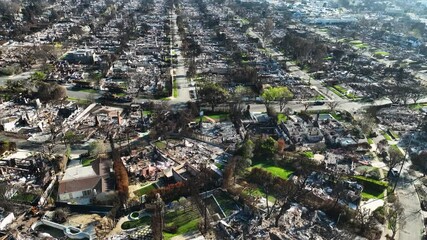 Aerial view rotating over a fire devastation area in Pacific Palisades, sunny LA