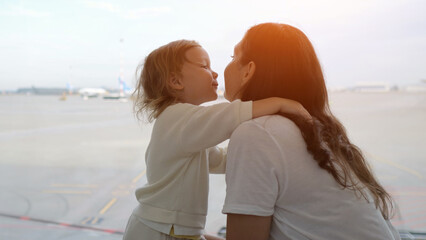 Mother and daughter sharing tender moments at the airport