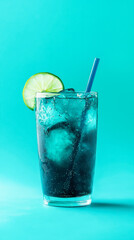 Refreshing blue cocktail with lime and straw in glass on turquoise background