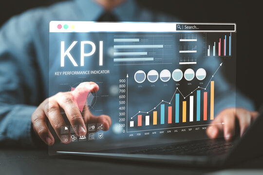 Businessman using digital screen to analyze key performance indicators (KPI) with various graphs and charts, showcasing data analysis and performance tracking. Analyzing Key Performance Indicators.