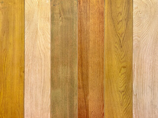 Close up of colorful solid wood plank painted in various colors. Natural brown, white, brown, and beige wood color tone. Seamless vintage wooden stripes background texture.