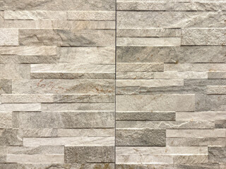 Natural rectangular cobblestone brick style texture with grey natural colors. Horizontal stripes of stone or rock tiles texture. Seamless background.