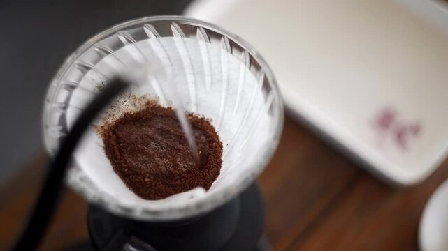 Close up of Hot water served in a paper filter for specialty coffee prepared in V60 method.