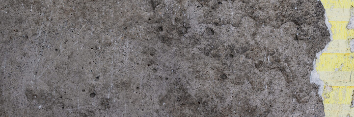 Torn old faded paper wallpaper with a retro pattern. Tattered scraps of paper on a concrete wall. Vintage texture for background and design. Closeup view with copy space.
