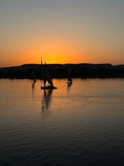 Felucca sailing on Nile River during sunset at Aswan, Egypt