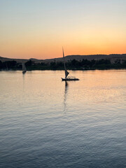 Felucca sailing on Nile River during sunset at Aswan, Egypt