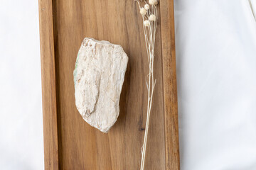 Top View of White Natural Pedestal Stone on Wooden Tray