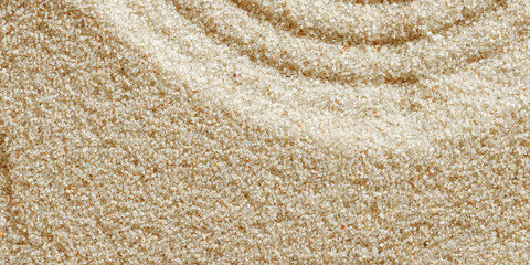 Zen lines on sand, beautiful sandy texture. Natural sand background for spa wellness, banner for relaxation balance and harmony, spirituality. Concentration and spirituality in Japanese zen garden