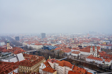 Graz cityscape on foggy day. Panoramic view of Graz, Austria with historical architecture. Streets with red roofed buildings in European city