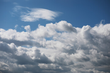 Fluffy White Clouds Against a Deep Blue Sky on a Sunny Day