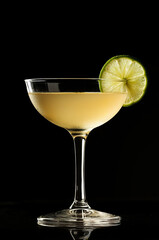 A classic Daiquiri in a coupe glass isolated on a black background