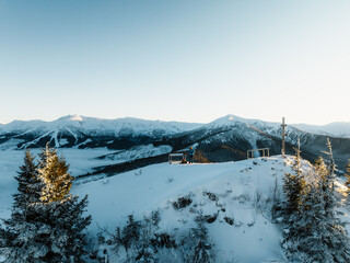 Winter hiking to Sina in Low Tatras National park near jasna is full of beautiful views. Sunset in Slovakia mountains with Chopok peak.