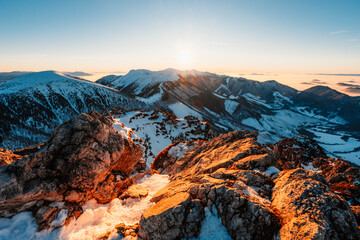 Obraz premium Winter hiking to Velky Rozsutec in Mala Fatra National park is full of beautiful views. Sunset in Slovakia mountains. Slovakia landscape