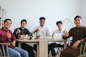 Portrait of Multiethnic Muslim Men Showing Thumbs Up on Dining Table During Iftar on Ramadan Feast