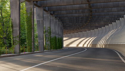 curved road under concrete bridge with sunlight shadows, urban tunnel with green ivy on pillars,...