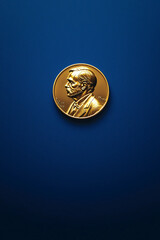 Close-up of the Nobel Prize medal with Alfred Nobel's portrait, positioned against a rich blue background, emphasizing the gold details and minimalist aesthetic.