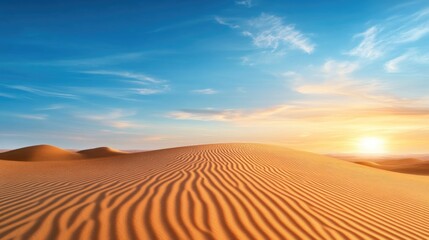 Naklejka premium Golden sand dunes under vibrant sunset with blue sky and clouds