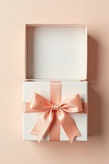 A delicately tied peach ribbon adorns a pristine white gift box, elegantly presented on a soft blush background, hinting at a special occasion or thoughtful surprise.