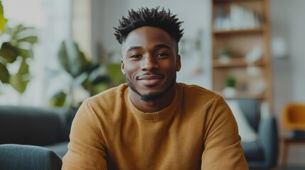 Fototapeta premium Confident and Friendly Young African Man in Casual Attire Smiling at the in an Office Setting