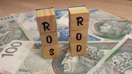 Polish PLN banknotes and ROS and ROD inscription made of letter cubes. Special bonds for family...