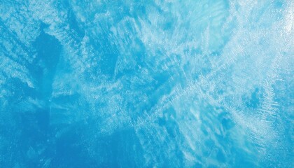 Fototapeta premium textured frozen ice surface with intricate frost patterns in vibrant blue tones, perfect for winter themed designs and background
