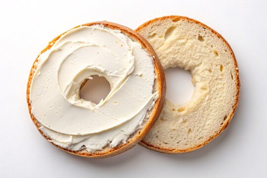 Plain bagel with cream cheese spread on white background, classic breakfast food