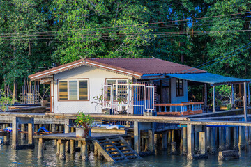 Obraz premium Panoramic nature background (mountains, sea, trees, twilight lights in the sky, waterfront communities), naturally blurred through the wind, seen on tourist spots or scenic spots