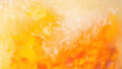 Obraz premium macro shot of frozen orange and yellow citrus fruit slice with icy texture, abstract vibrant background for food concepts