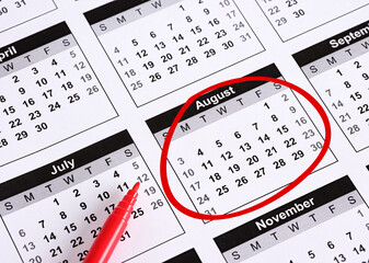 Red Marker Circling August on Calendar Page with Other Months Visible