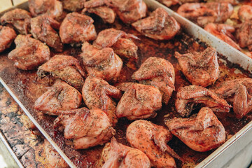 Tray of baked chicken legs baked in the oven with spices and herbs. Grilled chicken meat.
