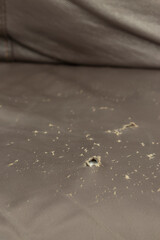 Worn ripped torn brown leather sofa couch textured cover background backdrop.