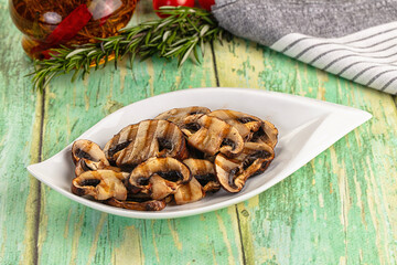 Tasty hot grilled champignon mushrooms