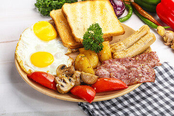 English breakfast with toast, egg and sausages