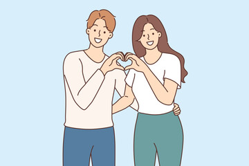 Man and woman in love make heart gesture together, demonstrating sympathy and affection for partner
