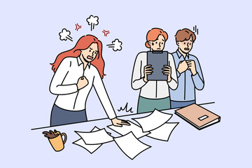 Angry woman manager shouts at frightened employees because of mistake or chaos in documents. Aggressive girl director with unbalanced psyche is angry at clerks who have not completed task