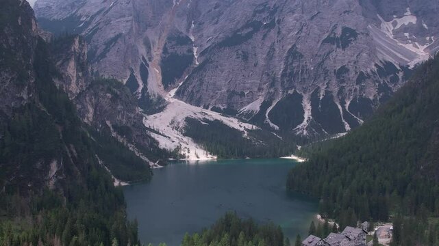 DRONE AERIAL FOOTAGE: View of Braies Lake (Pragser Wildsee), a blue mountain lake on Fanes-Senes-Braies with Croda del Becco mountain in the background, Dolomites, Trentino, South Tyrol, Italy.