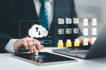 Cloud computing concept. Businessman uses a tablet and laptop with digital cloud storage and data...